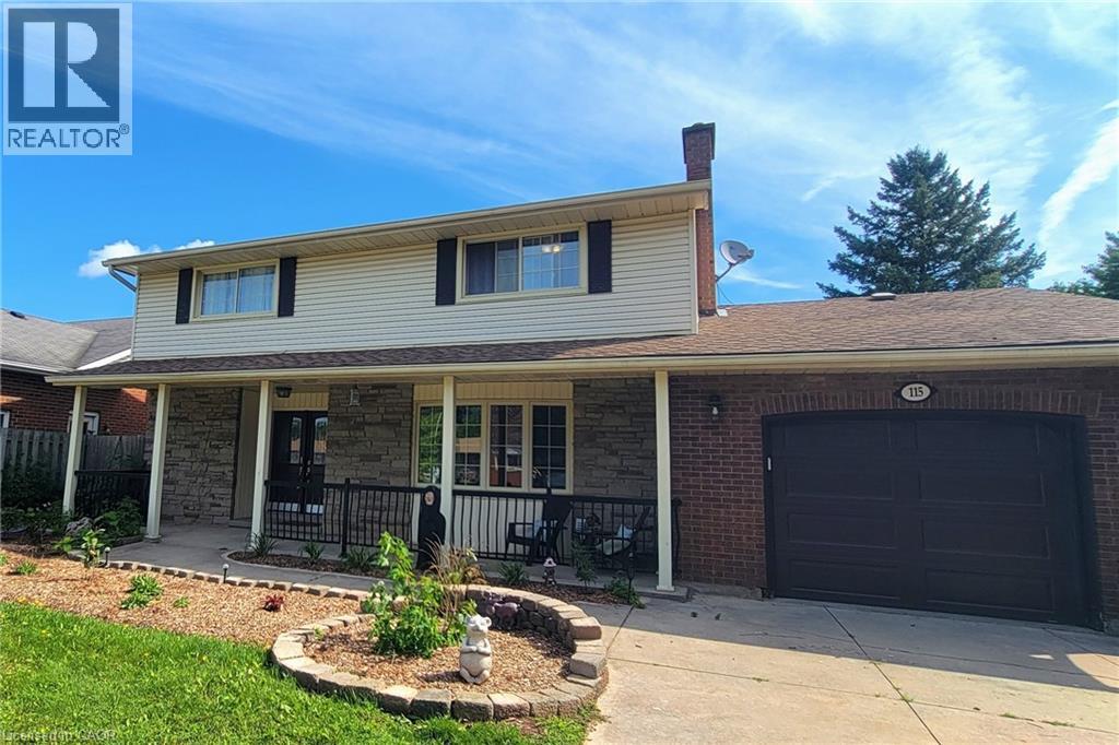 Front of this two-story colonial style, brick and siding home featuring a covered front porch, and attached one-car garage. - 115 Southwood Drive, Cambridge, ON