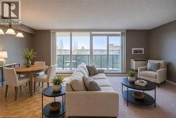 Living area with a textured ceiling, light colored carpet, and a chandelier Staged using AI - 