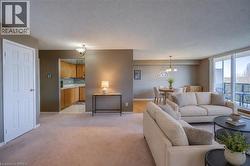 Living room featuring a textured ceiling, light carpet, and hanging lights. Staged using AI - 