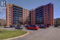 View of apartment building / complex featuring uncovered parking - 
