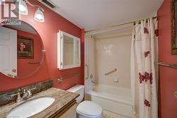 Bathroom with vanity and shower / bath combo with shower curtain - 