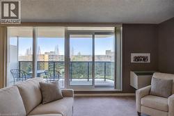 Carpeted living area featuring a textured ceiling and plenty of natural light Staged using AI - 