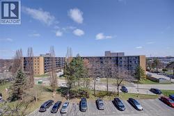 View of apartment building / complex with uncovered parking - 