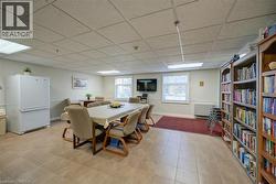 Dining area with a paneled ceiling and baseboards - 