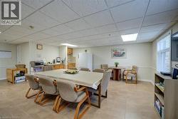 Dining room featuring a drop ceiling and baseboards - 