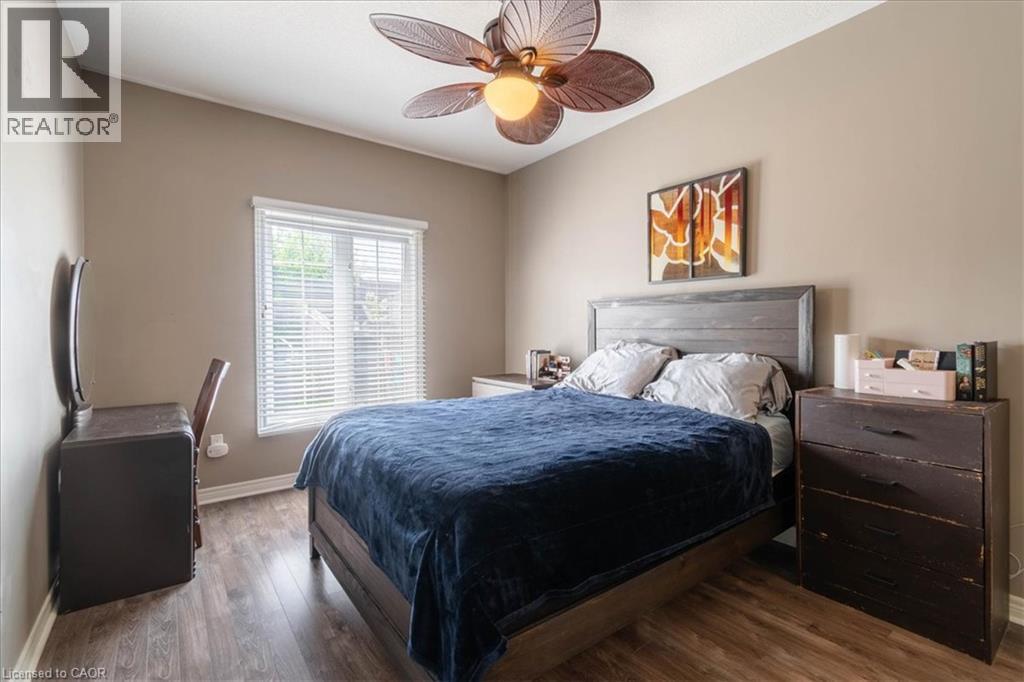Main Floor Primary Bedroom with en suite bathroom and his and hers closet - 20 Millcroft Drive, Simcoe, ON