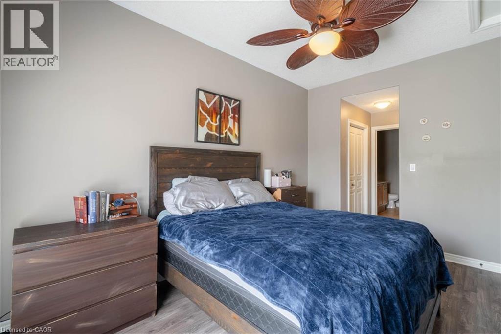 Main Floor Primary Bedroom with en suite bathroom and his and hers closet - 20 Millcroft Drive, Simcoe, ON