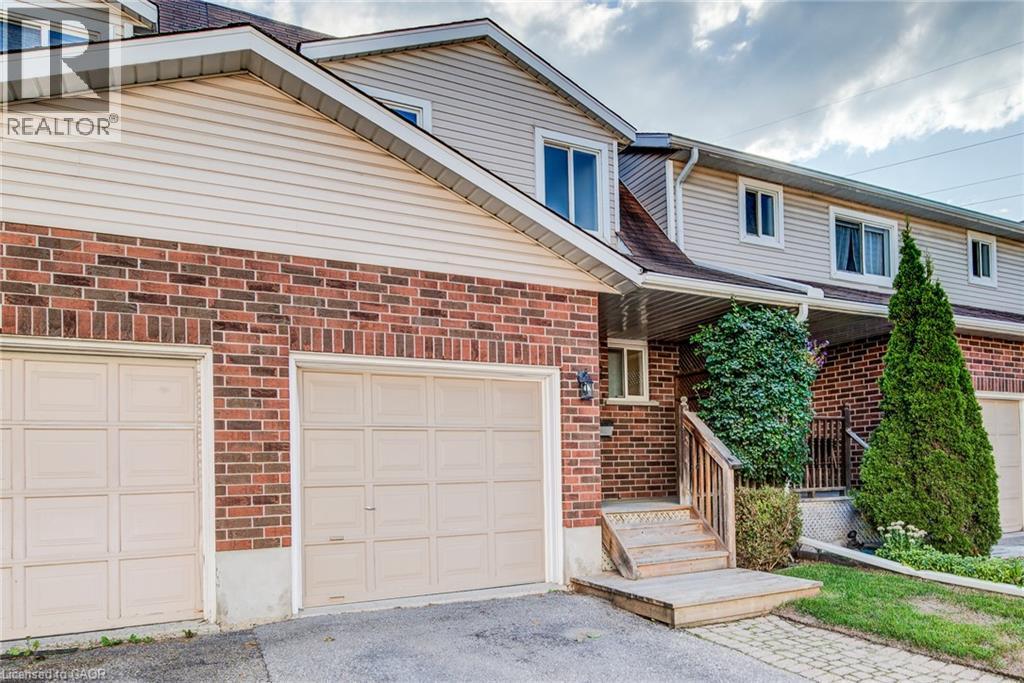 Brick and siding exterior with two garage doors - 360 Cornridge Place Unit# 2, Waterloo, ON