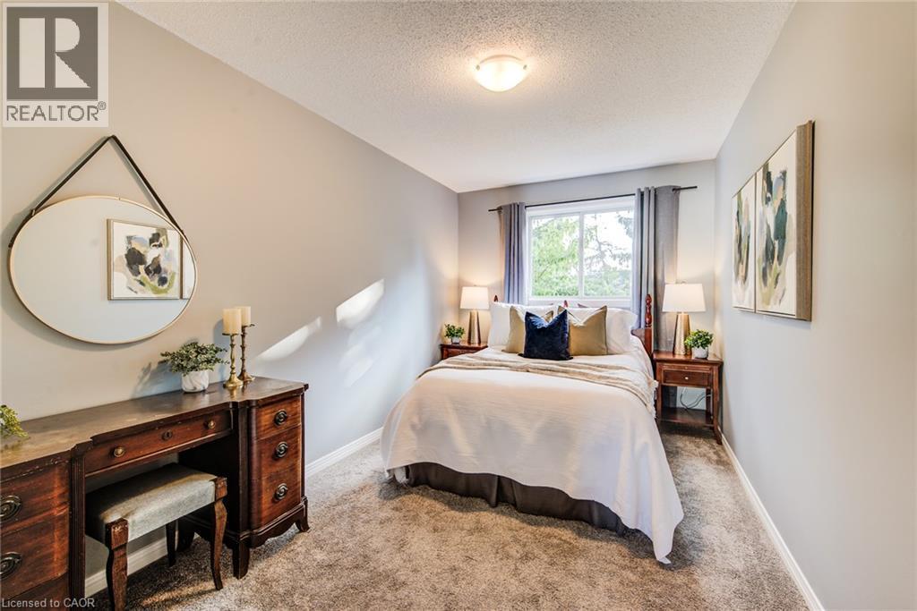 Wall-to-wall carpeting, overhead lighting, and a double-hung window - 360 Cornridge Place Unit# 2, Waterloo, ON