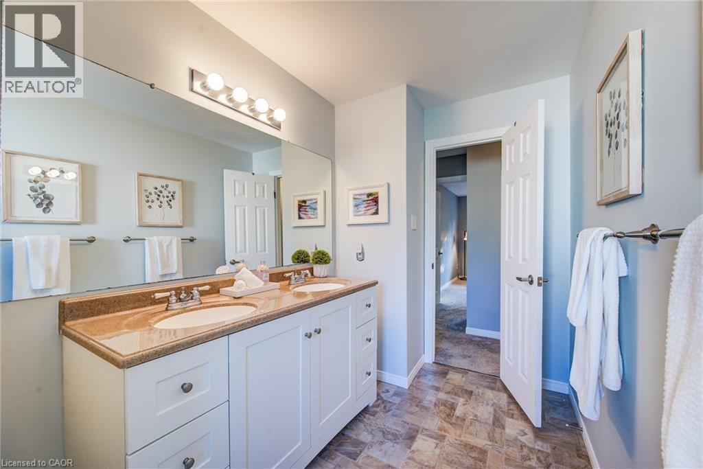 Dual vanity with undermount sinks, speckled countertop, and white cabinetry - 360 Cornridge Place Unit# 2, Waterloo, ON