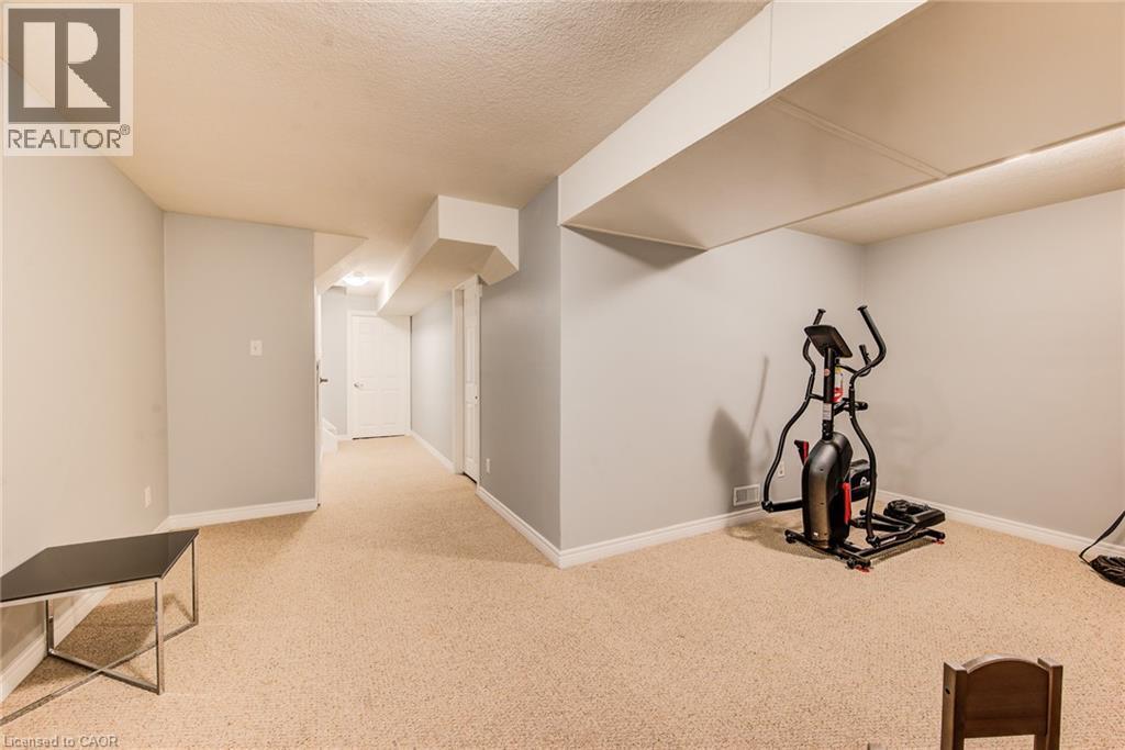 Carpeted flooring throughout, light gray wall paint, white trim, and white doors - 360 Cornridge Place Unit# 2, Waterloo, ON
