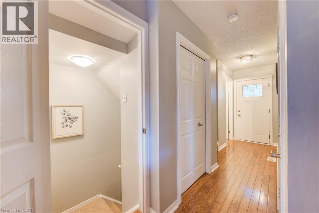 Hardwood-style flooring throughout the hallway - 360 Cornridge Place Unit# 2, Waterloo, ON