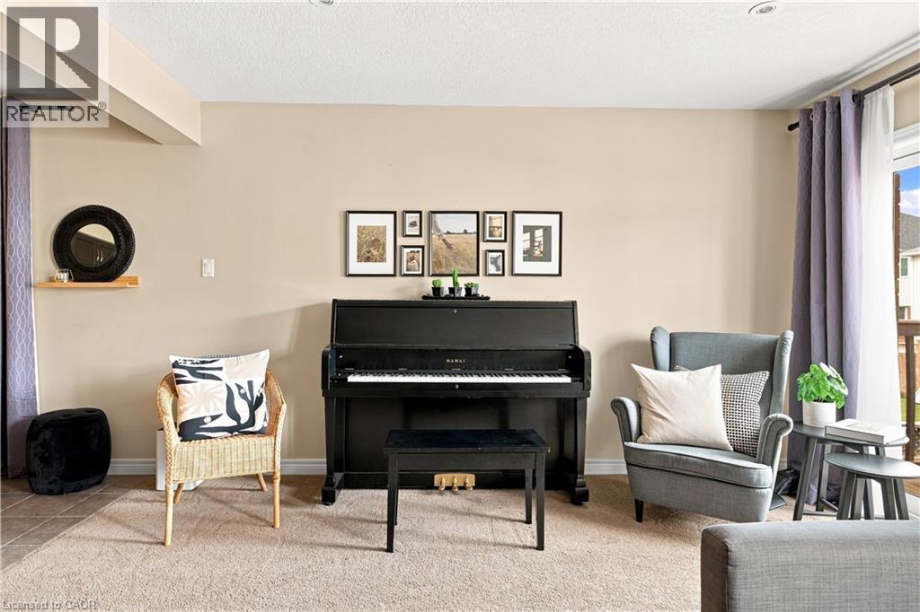 Neutral wall paint throughout, recessed ceiling lighting, textured carpet flooring, and a glass-paneled exterior door - 187 Eden Oak Trail, Kitchener, ON