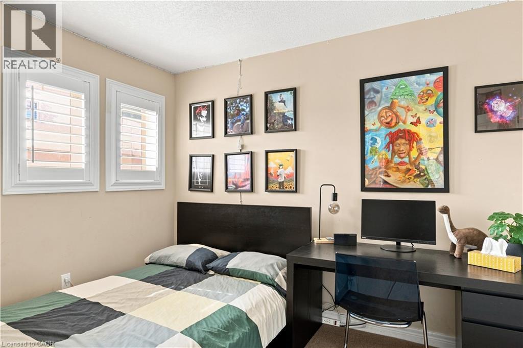 Two windows featuring white plantation shutters - 187 Eden Oak Trail, Kitchener, ON