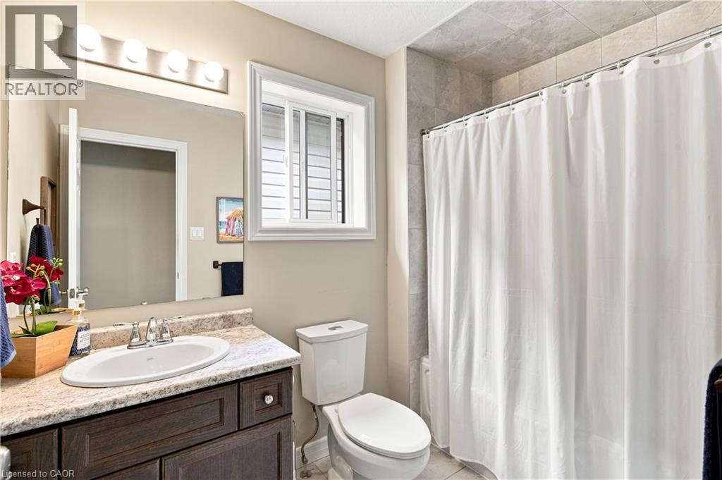 Vanity with an integrated sink, polished chrome faucet, and stone-finish countertop - 187 Eden Oak Trail, Kitchener, ON