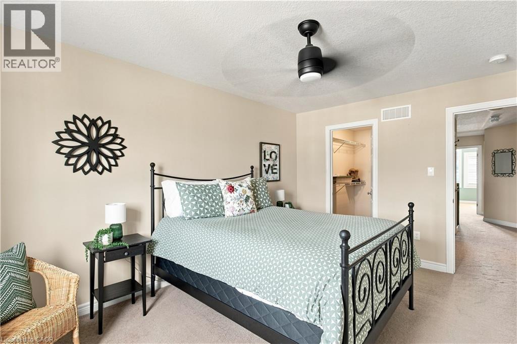 Recessed lighting, ceiling fan, and neutral wall paint complement the bedroom's design - 187 Eden Oak Trail, Kitchener, ON