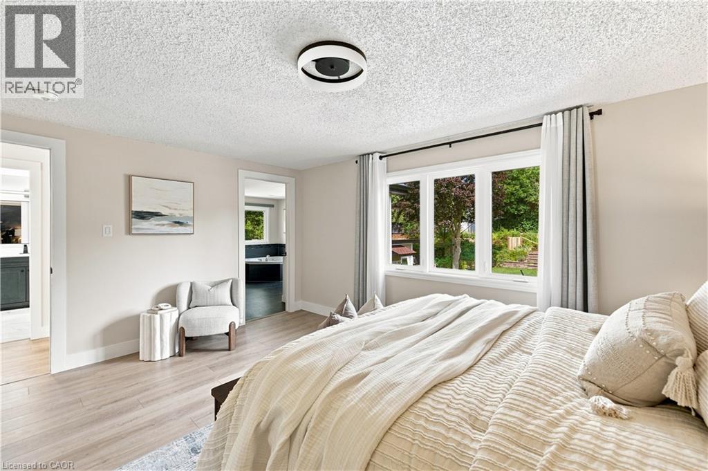 Recessed lighting, wood-finish flooring, and white trim throughout - 62 Corfield Drive, Kitchener, ON