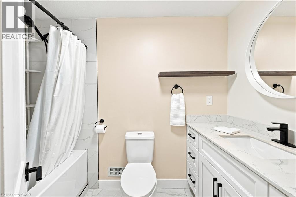White vanity with dark hardware, a white countertop, and a black faucet - 62 Corfield Drive, Kitchener, ON