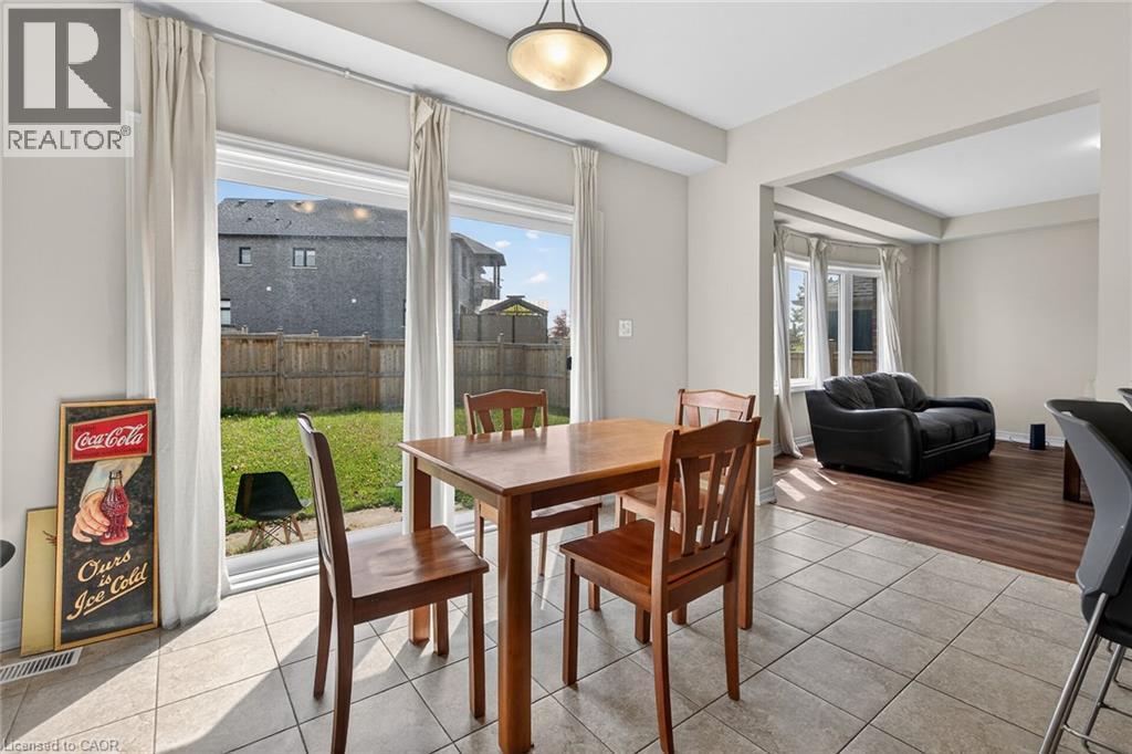 Tiled flooring, double sliding glass door, recessed lighting, wood-finish flooring, and bay windows - 9 Winterberry Boulevard, Thorold, ON