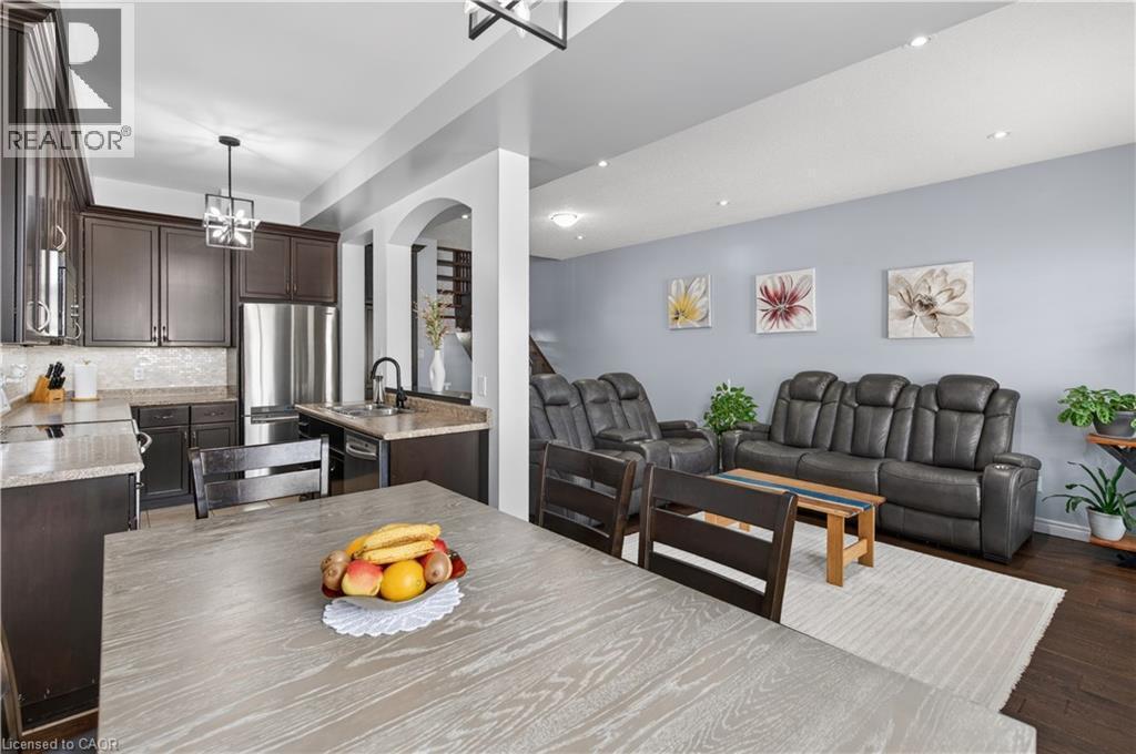 Dark wood-finish cabinetry, stainless steel appliances, recessed ceiling lighting, and archway architectural detailing - 88 Highgate Drive, Hamilton, ON
