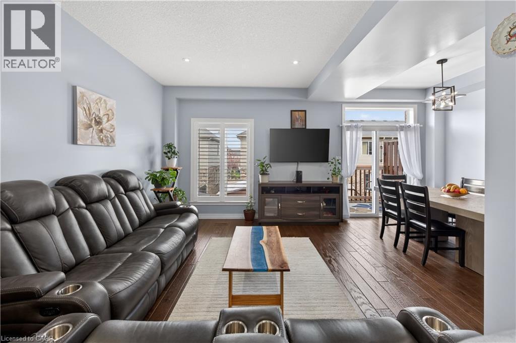 Wood-finish flooring throughout, recessed lighting, and a sliding glass door - 88 Highgate Drive, Hamilton, ON
