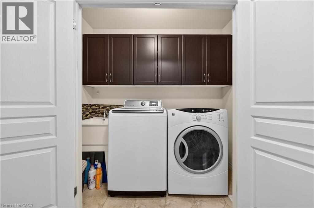 Built-in cabinetry, utility sink, and tile flooring - 88 Highgate Drive, Hamilton, ON