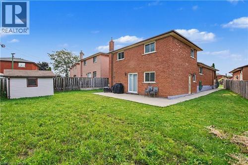 Expansive grass lawn with a storage shed and privacy fencing - 14 Indian Crescent, Hamilton, ON 