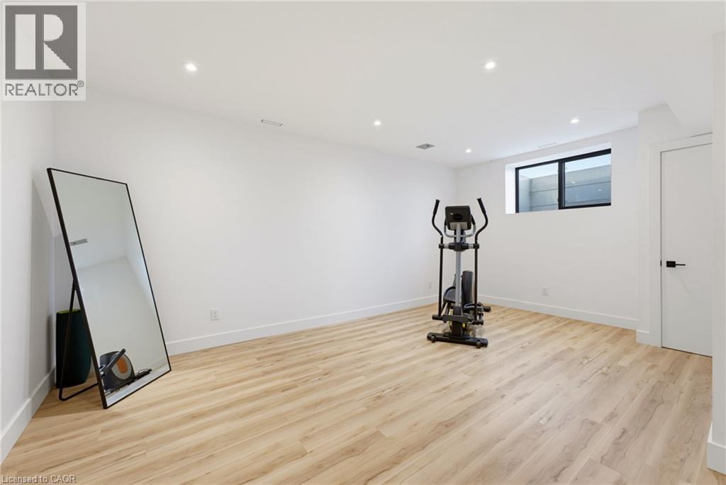 Recessed lighting, wood-finish flooring, and a large window with a black frame - 5709 Forth Line, Hillsburg, ON