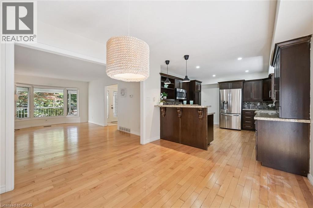 Open-concept living area featuring light wood-finish flooring throughout - 345 Beechlawn Drive, Waterloo, ON