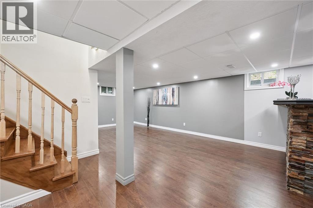 Finished lower level featuring wood-finish flooring and recessed lighting - 345 Beechlawn Drive, Waterloo, ON