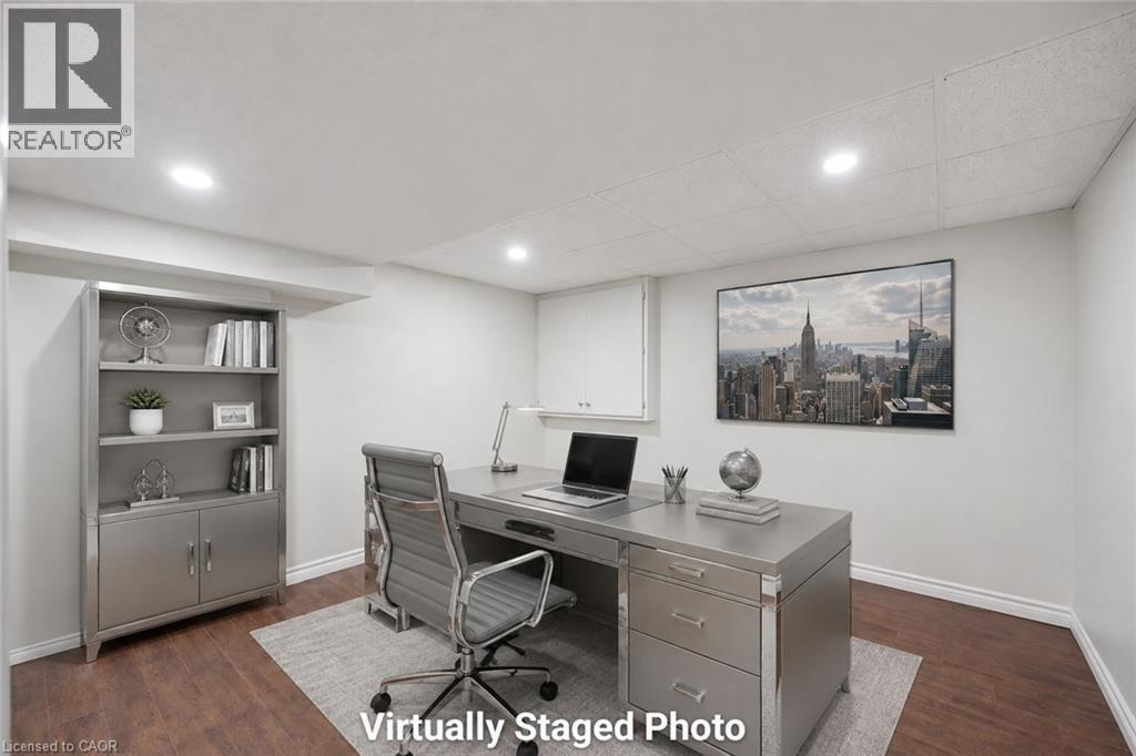 Recessed lighting illuminates this room featuring wood-finish flooring and light-toned walls - 345 Beechlawn Drive, Waterloo, ON