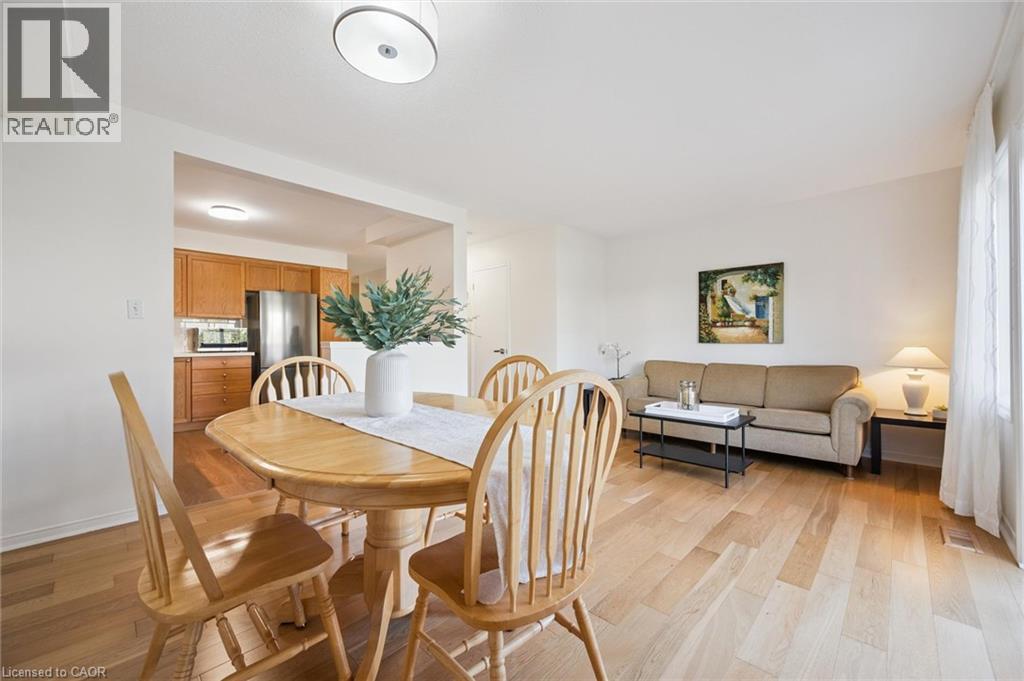 Hardwood-finish flooring throughout, recessed lighting, and a kitchen with wood cabinetry and stainless-steel appliances - 151 Clairfields Drive Unit# 3, Guelph, ON
