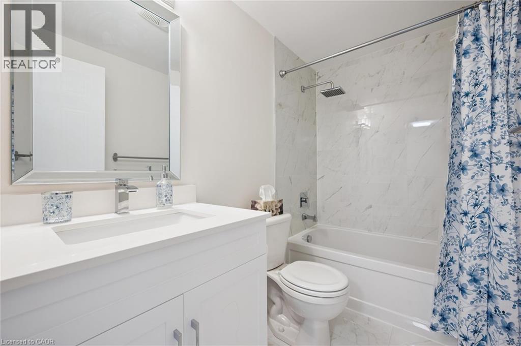 White vanity with an integrated sink and chrome faucet - 151 Clairfields Drive Unit# 3, Guelph, ON