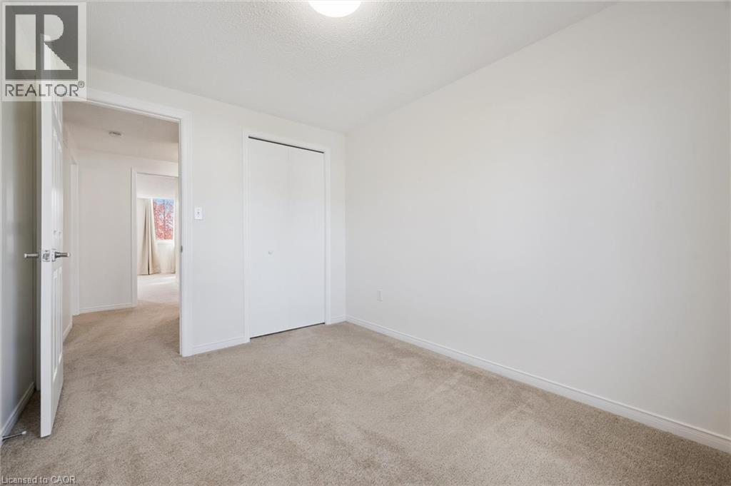 Neutral wall paint, light-toned carpet, and a flush mount ceiling light - 151 Clairfields Drive Unit# 3, Guelph, ON