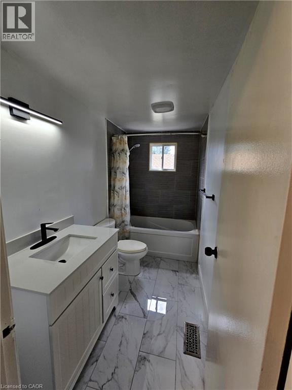 White vanity with a rectangular undermount sink and matte black faucet - 99 Cluthe Crescent, Kitchener, ON