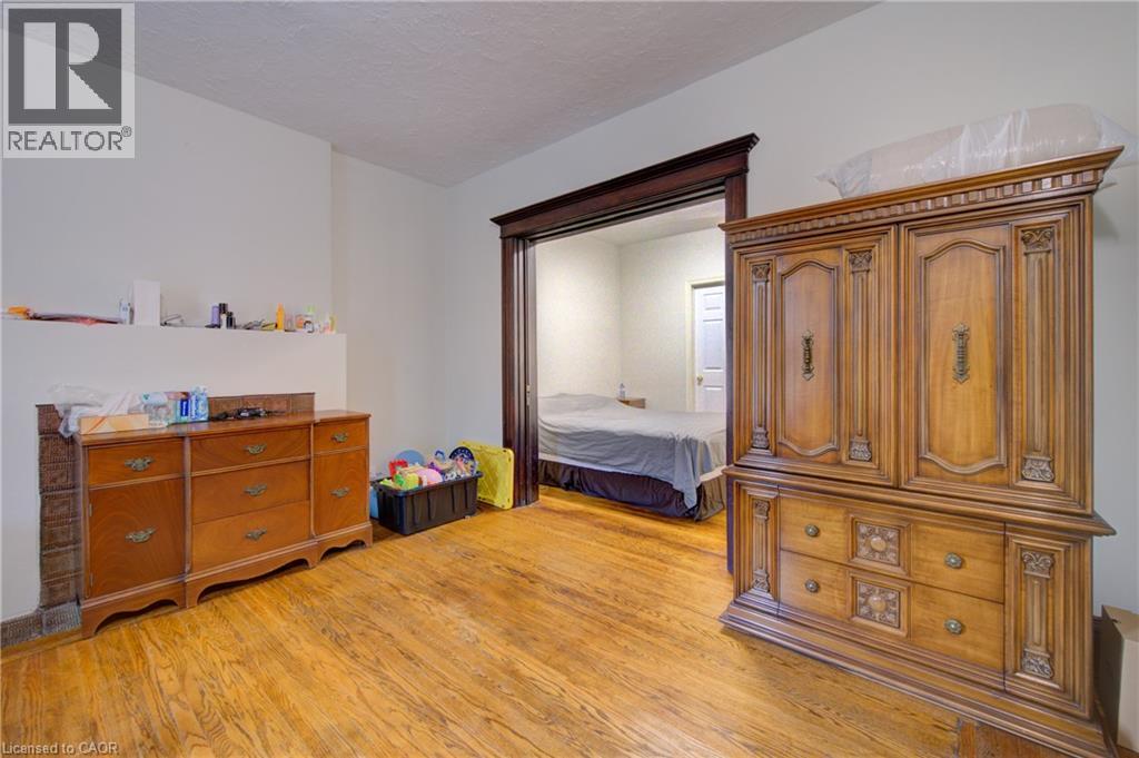 private livingroom for Primary bedroom 1 with private 3 piece ensuite bath. pocket doors - 24 Hunt Street, Hamilton, ON