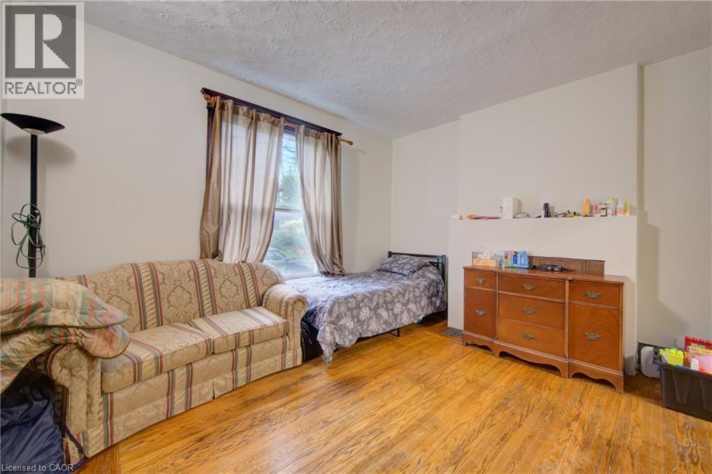 private livingroom with pocket doors to primary bedroom 1 - 24 Hunt Street, Hamilton, ON