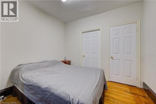 primary bedroom 1 with pocket doors to private livingroom, private 3 piece ensuite bath - 24 Hunt Street, Hamilton, ON 