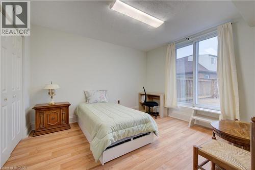 Bedroom 2 with private deck overlooking backyard - 24 Hunt Street, Hamilton, ON 
