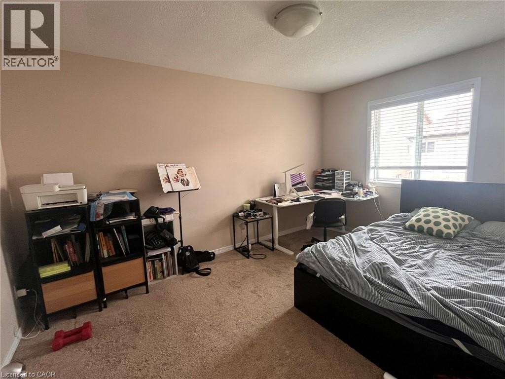 Recessed ceiling light fixture, neutral wall paint, window with blinds, carpeted flooring, built-in shelving units - 298 Buttonbush Street, Waterloo, ON