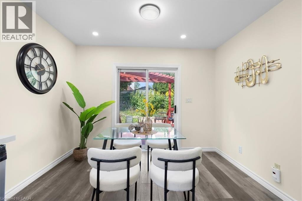 Wood-finish flooring, recessed lighting, and a sliding glass door - 150 Bankside Drive, Kitchener, ON