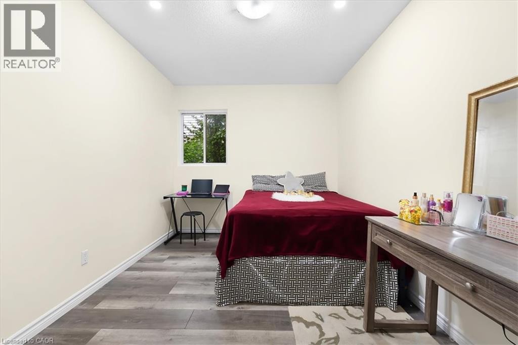 Recessed lighting, wood-finish flooring, white walls, and a window for natural light - 150 Bankside Drive, Kitchener, ON