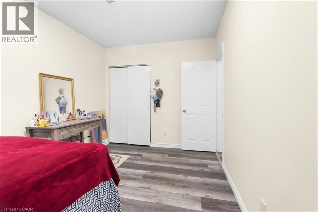 Wood-finish flooring and light-toned walls - 150 Bankside Drive, Kitchener, ON
