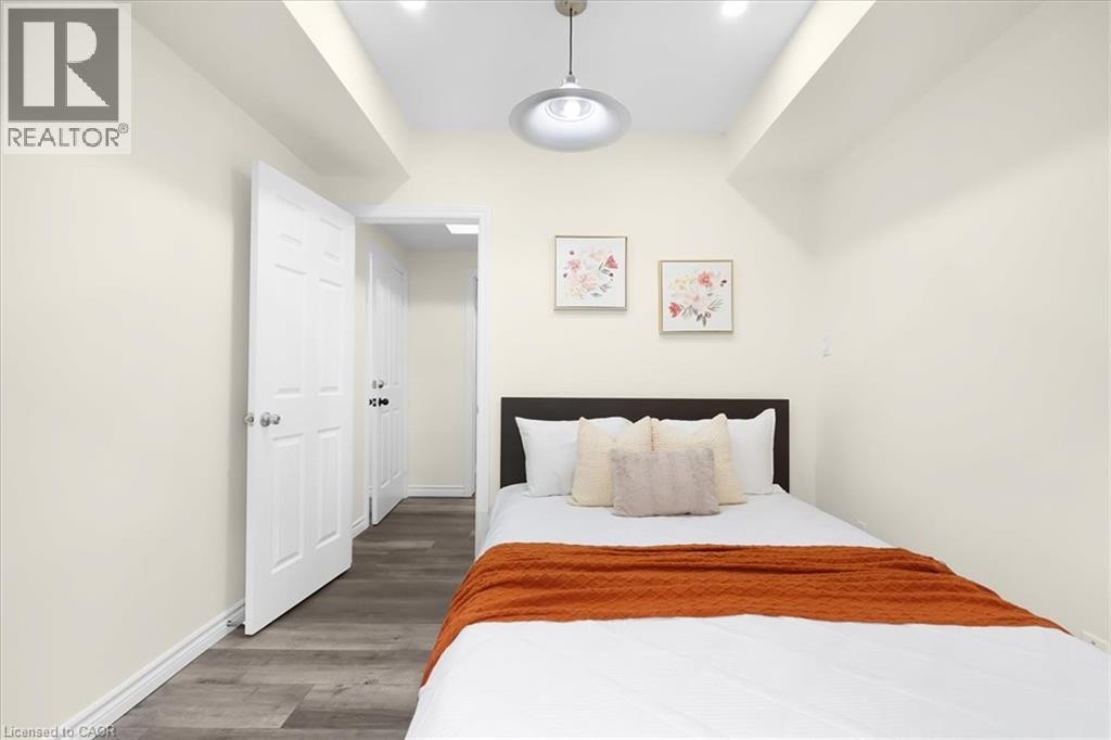 Recessed lighting and a central pendant fixture illuminate the space - 150 Bankside Drive, Kitchener, ON