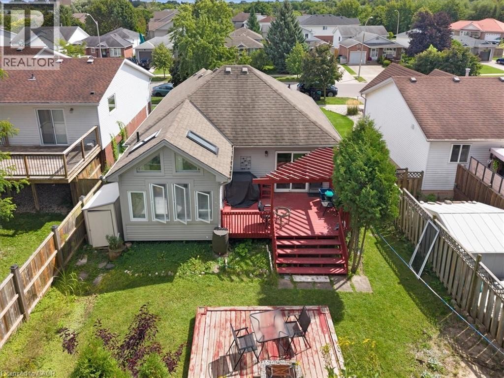 Expansive backyard featuring a multi-level wood deck, pergola, and detached shed - 150 Bankside Drive, Kitchener, ON