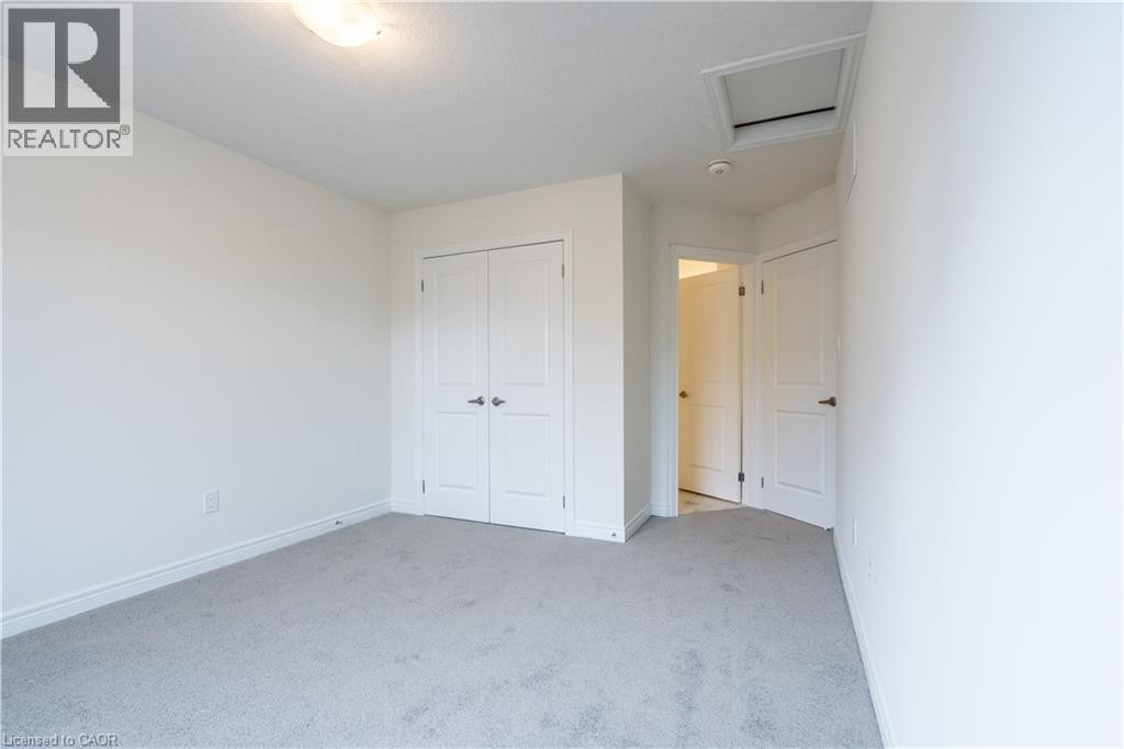 Neutral wall color, light gray carpeting, and white trim - 23 Dryden Lane, Hamilton, ON