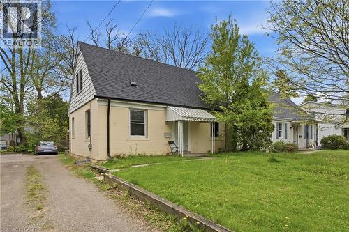 Gabled home featuring a light-colored stucco exterior and an asphalt shingle roof - 139 Dalewood Avenue, Hamilton, ON 