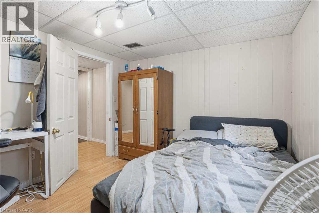 Recessed ceiling panels, track lighting, and wood-finish flooring characterize this room - 139 Dalewood Avenue, Hamilton, ON