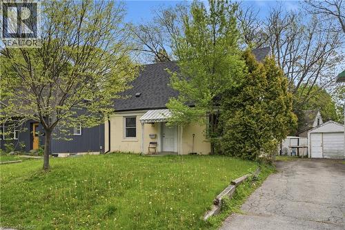 Single-story residence with a light-colored stucco exterior, dark shingled roof, and a front awning - 139 Dalewood Avenue, Hamilton, ON 