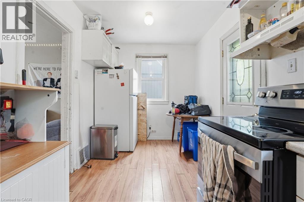 Kitchen featuring wood-finish flooring and white walls - 139 Dalewood Avenue, Hamilton, ON